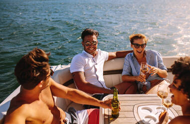 Young people partying on a boat. Men and women laughing and enjoying at yacht party. - JLPSF18507