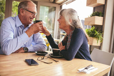 Happy senior couple on a date at coffee shop and talking. Elderly man and woman relaxing at cafe and having coffee. - JLPSF18849