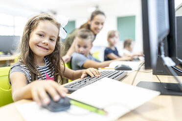 Lächelnder Schüler im Computerkurs in der Schule - WESTF25193