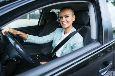 Smiling businesswoman sitting in car - OIPF02525