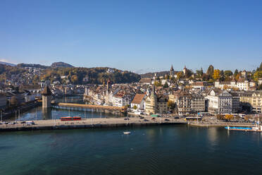 Switzerland, Canton of Lucerne, Lucerne, Aerial view of lakeshore city in autumn - TAMF03563