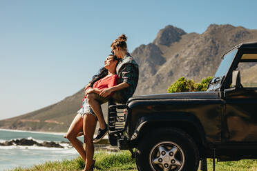 Romantic young couple sharing a special moment on roadtrip. Couple in love by their car at the beach. - JLPSF21150