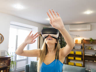Happy woman wearing virtual reality simulator - AMRF00115