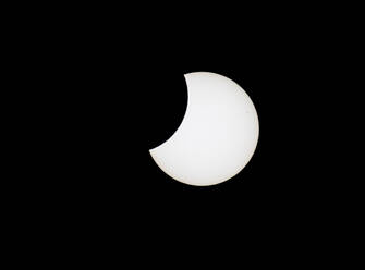 Partial solar eclipse against black sky - ZCF01102