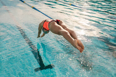 Low section of girl wearing striped underwear while diving into