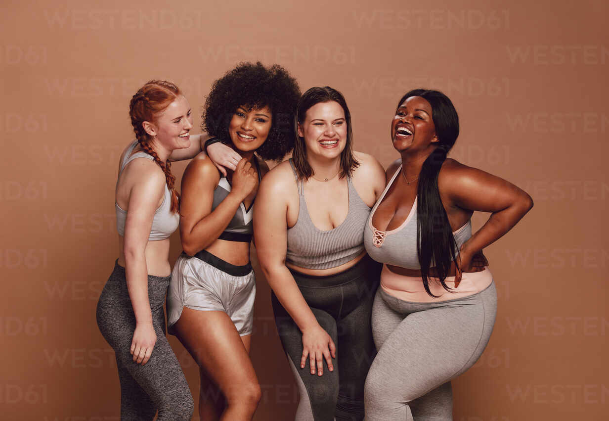 Unrecognizable natural female bodies in a studio. Diverse group of