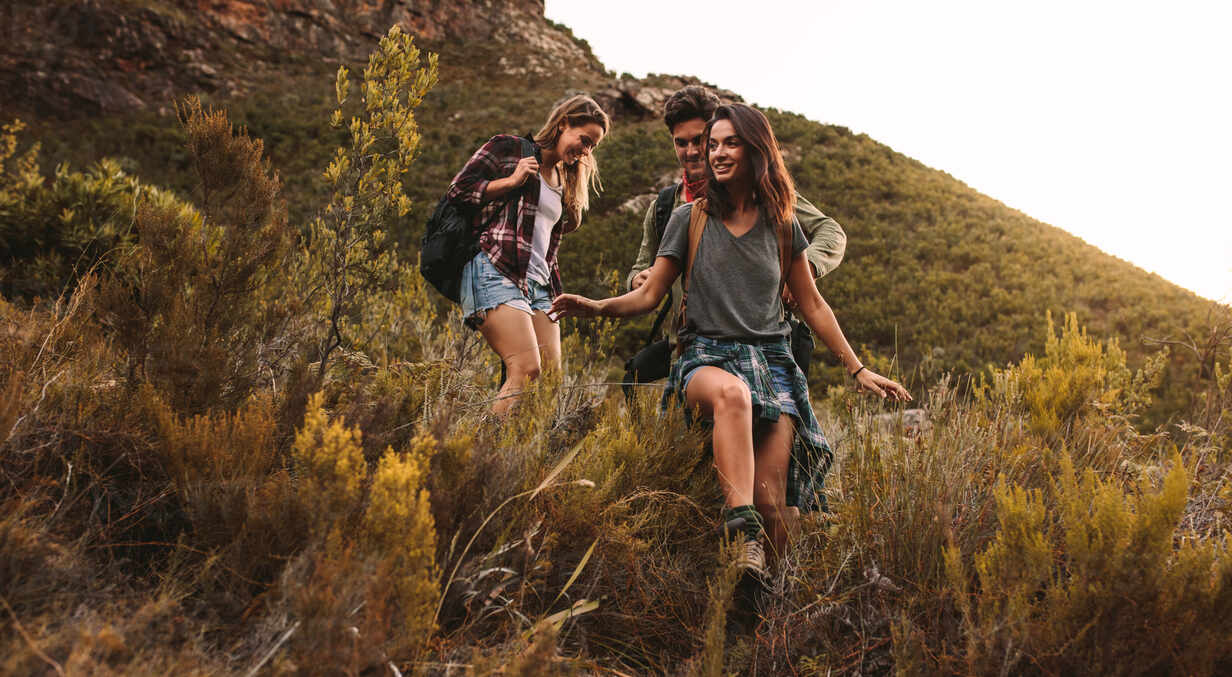 Two beautiful women hiking in nature on a mountain road Stock Photo - Alamy