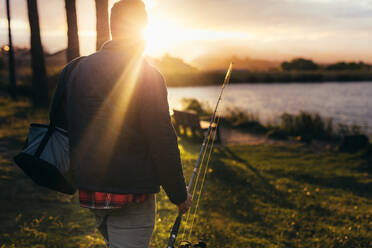 Old man fishing, serene lake, fishing rod, hat, content smile 29917481  Stock Photo at Vecteezy