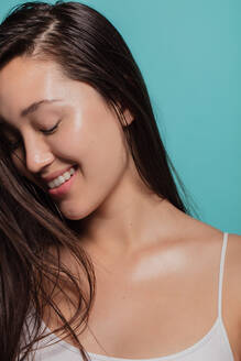 Charming young asian woman against blue background. Natural looking asian girl. - JLPSF22972