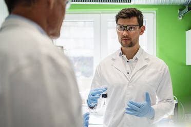 Scientist with colleague having discussion at laboratory - DIGF19260