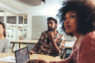 Coworkers sitzen in Konferenzraum diskutieren Arbeit. Business-Frau im Büro sitzen mit Laptop in einer Sitzung mit Kollegen. - JLPSF24421