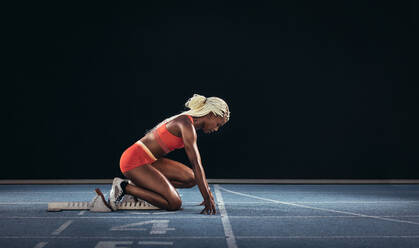 Women Running On Athletic Track by Jupiterimages