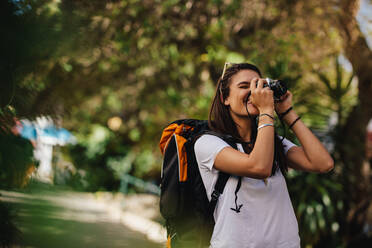 Wanderin, die die Aussicht fotografiert. Frau mit Rucksack, die die Aussicht mit ihrer Kamera festhält. - JLPSF24782