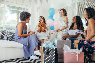 Schwangere Frau feiert Baby Shower Party mit Freunden. Schwangere Frau erhält Geschenke von Freunden. - JLPSF25490