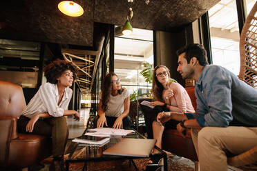 Group of creative people having a meeting in a modern office. Business people having conversation over new project. - JLPSF25786