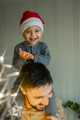 Happy son and father at home on Christmas - ANAF00354