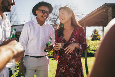 Group of multiracial friends hanging out together at outdoors restaurant. Young men and woman having party. - JLPSF25962