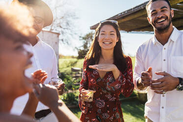 Friends at reunion party outdoors. Group of people at having party in outdoors restaurant. - JLPSF25968