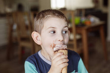 Boy eating ice cream at home - OSF01111