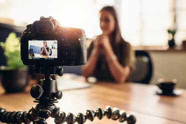 Female vlogger recording content for her video blog. Young woman in focus on digital camera screen. - JLPSF26964