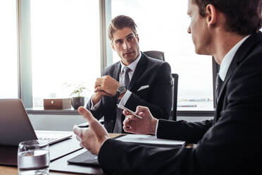 Businessman listening to his partner during a strategy meeting. Corporate professionals having discussion in office. - JLPSF27028