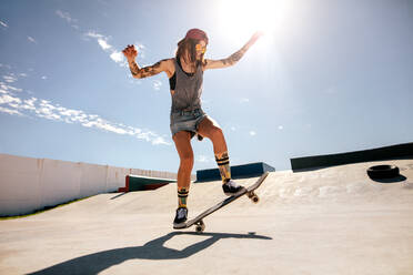 Weibliche Skaterin auf dem Skateboard im Skatepark, Frauen machen Tricks auf dem Skateboard. - JLPSF27183