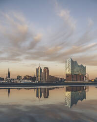 Germany, Hamburg, Elbphilharmonie reflecting in Elbe river at dusk - KEBF02447