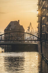 Germany, Hamburg, Canal in Speicherstadt district at sunset - KEBF02459