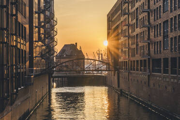 Germany, Hamburg, Canal in Speicherstadt district at sunset - KEBF02460