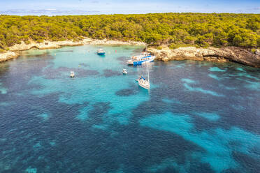 Spain, Balearic Islands, Menorca, Aerial view of boats in Cala Turqueta bay - SMAF02357