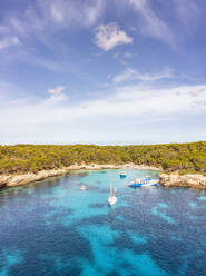 Spain, Balearic Islands, Menorca, Aerial view of boats in Cala Turqueta bay - SMAF02359