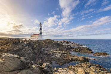 Spain, Balearic Islands, Menorca, Far de Favaritx lighthouse at sunset - SMAF02391