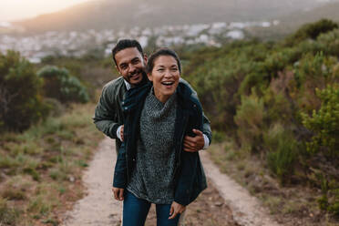 Portrait of happy young couple having fun on their hiking trip. Hiker couple enjoying themselves on vacation. - JLPSF27543