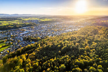 Germany, Baden-Wurttemberg, Drone view of sun setting over town in Vilstal valley - STSF03608