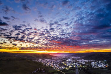 Germany, Baden-Wurttemberg, Drone view of town in Remstal valley at dramatic sunrise - STSF03613