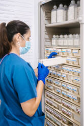 Nurse taking inventory of medical supplies at hospital - MMPF00444