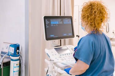 Nurse operating ultrasound machine at hospital - MMPF00464