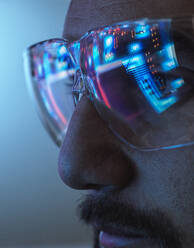 Reflection of circuit board on engineer's eyeglasses - ABRF01008