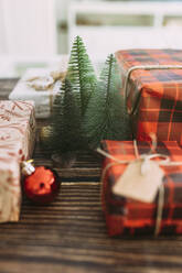 Christmas tree amidst gifts on table - EGHF00625