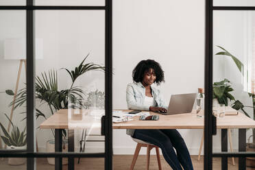 Freelancer working on laptop at home office - EBBF06929