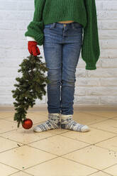 Girl standing with Christmas tree - IEF00209