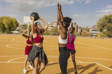 Four women having an outdoor boot camp workout stock photo