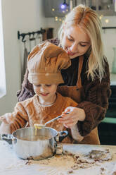 Happy mother and son preparing cookies at home - VSNF00128