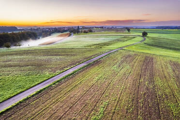 Germany, Baden-Wurttemberg, Drone view of autumn fields in Swabian-Franconian Forest at foggy dawn - STSF03660