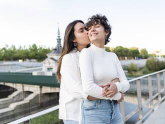Romantic woman kissing and hugging lesbian friend - AMRF00160
