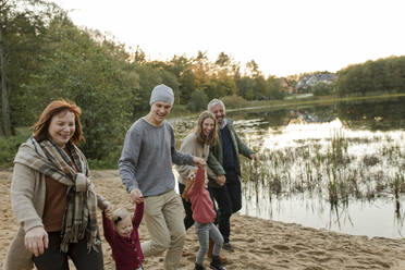 Happy family having fun with each other by lake - VIVF00210