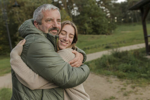 Contemplative father embracing happy daughter - VIVF00229