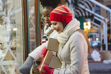 Excited women doing window shopping at Christmas festival - OSF01134