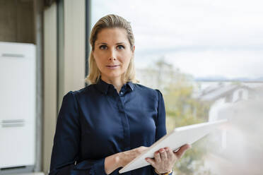 Confident businesswoman with tablet computer in office - DIGF19578