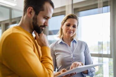 Business colleagues discussing over tablet PC at office - DIGF19603